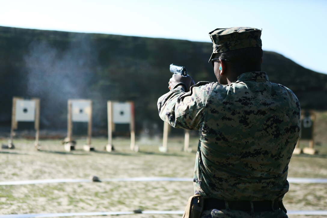 MIHAIL KOGALNICEANU, Romania - Staff Sgt. Brian Hemphill, a Marine with 3rd Battalion, 8th Marines, assigned to Black Sea Rotational Force 14, fires an M9 pistol while he participates in routine weapons exercises at Mihail Kogalniceanu, Romania, March 14, 2014. BSRF-14 is a contingent of Marines and sailors in the Black Sea, Balkans and Caucasus regions that work with partner nations to maintain proven partnerships while building military capacity, promoting regional stability, and providing the capability for rapid crisis response throughout Eastern Europe as directed by U.S. Marine Corps Forces Europe and Africa, U.S. European Command.