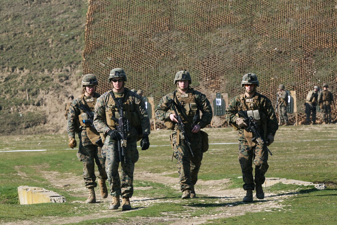 MIHAIL KOGALNICEANU, Romania - U.S. Marines with Black Sea Rotational Force 14 from Weapons Company, 3rd Battalion, 8th Marines, walk back from the firing line while they participate in routine weapons exercises at Mihail Kogalniceanu, Romania, March 14, 2014. BSRF-14 is a contingent of Marines and sailors in the Black Sea, Balkans and Caucasus regions that work with partner nations to maintain proven partnerships while building military capacity, promoting regional stability, and providing the capability for rapid crisis response throughout Eastern Europe as directed by U.S. Marine Corps Forces Europe and Africa, U.S. European Command. (U.S. Marine Corps photo by Lance Cpl. Samantha A. Barajas, 2nd Marine Division, Combat Camera/ Released)