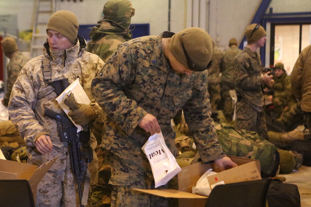 Marines with 2nd Supply Battalion, Combat Logistics Regiment 25, 2nd Marine Logistics Group take Meals, Cold Weather during the drawdown of Cold Response 14 at Evenes, Norway, March 19, 2014. MCWs contain meals with more calories and additional drink mixes to encourage hydration in climates that require more energy per day, but where many people prefer not to drink. Cold Response 14 is a Norwegian-led multinational exercise above the Arctic Circle designed prepare for high-intensity cold-weather operations with nearly 16,000 troops from 16 different countries.