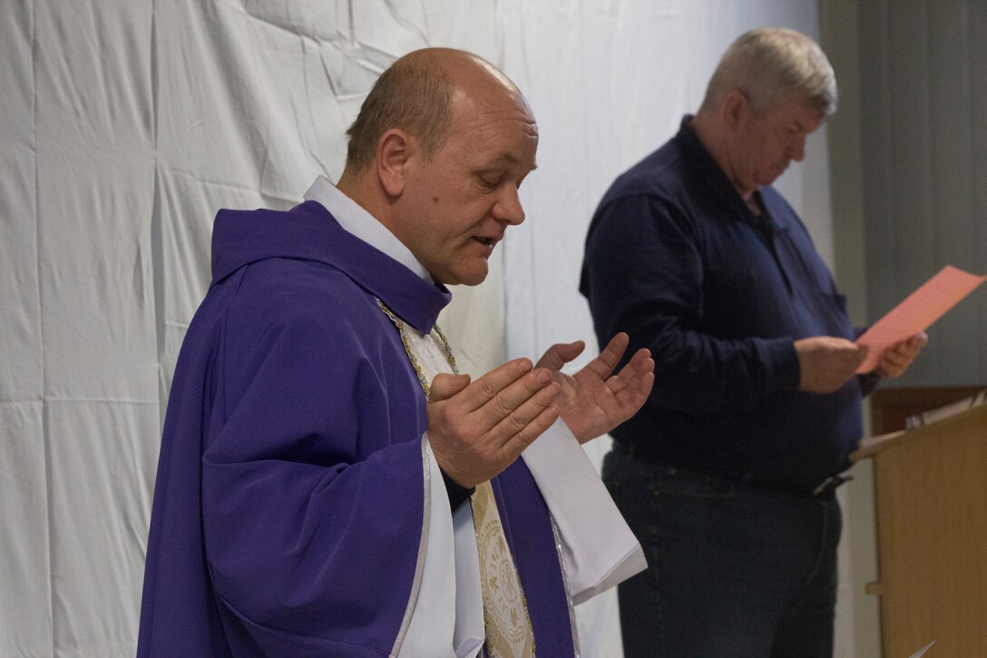 MIHAIL KOGALNICEANU, Romania - Romanian Catholic priest Balint Petre leads the Ash Wednesday service at Mihail Kogalniceanu Air Base, Mihail Kogalniceanu, Romania, March 5, 2014. Black Sea Rotational Force-14 is a contingent of Marines and sailors in the Black Sea, Balkans and Caucasus regions that work with partner nations and maintains proven partnerships while building military capacity, promoting regional stability, and providing the capability for rapid crisis response throughout Eastern Europe as directed by U.S. Marine Corps Forces Europe and Africa, and U.S. European Command. (U.S. Marine Corps photo by Lance Cpl. Samantha A. Barajas, Combat Camera, 2nd Marine Division/Released)