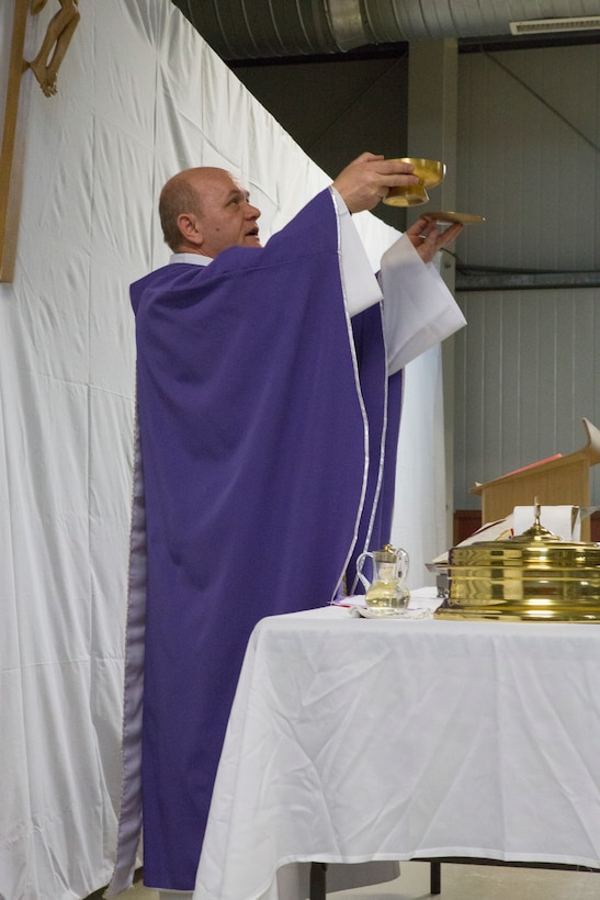 MIHAIL KOGALNICEANU, Romania - Romanian priest Balint Petre leads the Ash Wednesday service for U.S. military members at Mihail Kogalniceanu Air Base, Mihail Kogalniceanu, Romania, March 5, 2014. Black Sea Rotational Force 14 (BSRF-14) is a contingent of Marines and sailors in the Black Sea, Balkans and Caucasus regions that work with partner nations and maintains proven partnerships while building military capacity, promoting regional stability, and providing the capability for rapid crisis response throughout Eastern Europe as directed by U.S. Marine Corps Forces Europe and Africa, and U.S. European Command. (U.S. Marine Corps photo by Lance Cpl. Samantha A. Barajas, Combat Camera, 2nd Marine Division/Released)
