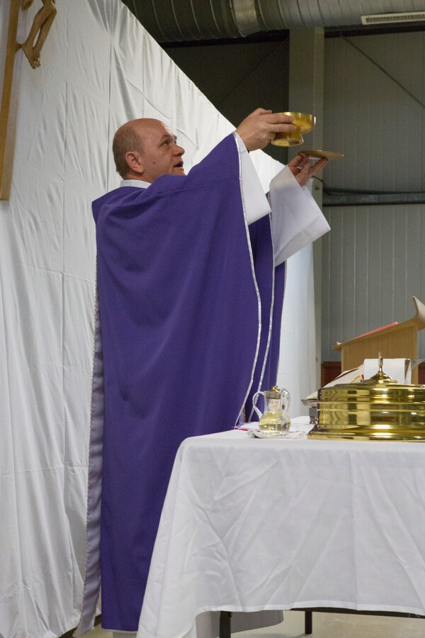 MIHAIL KOGALNICEANU, Romania - Romanian priest Balint Petre leads the Ash Wednesday service for U.S. military members at Mihail Kogalniceanu Air Base, Mihail Kogalniceanu, Romania, March 5, 2014. Black Sea Rotational Force 14 (BSRF-14) is a contingent of Marines and sailors in the Black Sea, Balkans and Caucasus regions that work with partner nations and maintains proven partnerships while building military capacity, promoting regional stability, and providing the capability for rapid crisis response throughout Eastern Europe as directed by U.S. Marine Corps Forces Europe and Africa, and U.S. European Command. (U.S. Marine Corps photo by Lance Cpl. Samantha A. Barajas, Combat Camera, 2nd Marine Division/Released)
