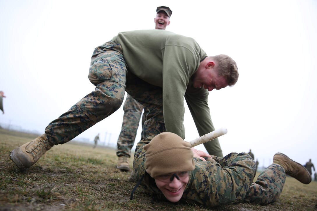 MIHAIL KOGALNICEANU, Romania - Corporal Landon Amburn, a Marine with Weapons Company, 3rd Battalion, 8th Marine Regiment, 2nd Marine Division and part of Black Sea Rotational Force 14, subdues a simulated enemy during a mechanical arm control holds course after being exposed to oleoresin capsicum spray on Mihail Kogalniceanu Air Base, Romania, March 5, 2014. The Marines were directly exposed to the OC spray, then instructed to complete a course with different stations which required them to execute different take down techniques on a simulated enemy combatant. Black Sea Rotational Force 14 is a contingent of Marines to maintain positive relations with partner nations, regional stability and increase interoperability while providing the capability for rapid crisis response, as directed by U.S. European Command, in the Black Sea, Balkan and Caucus regions of Eastern Europe. 
