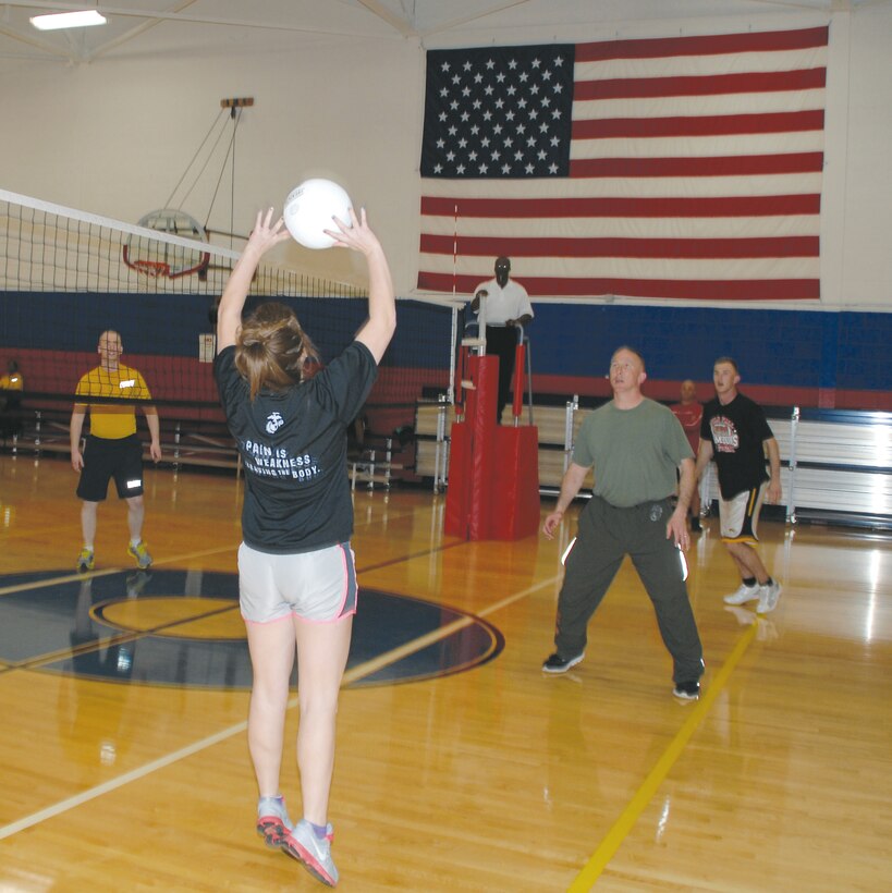 Dubbers Drubbers’ team captain Alyssa Forness, sets up Col. Don Davis, commanding officer, Marine Corps Logistics Base Albany, Monday, during 2014 intramural volleyball regular season game at Thomason Gymnasium.