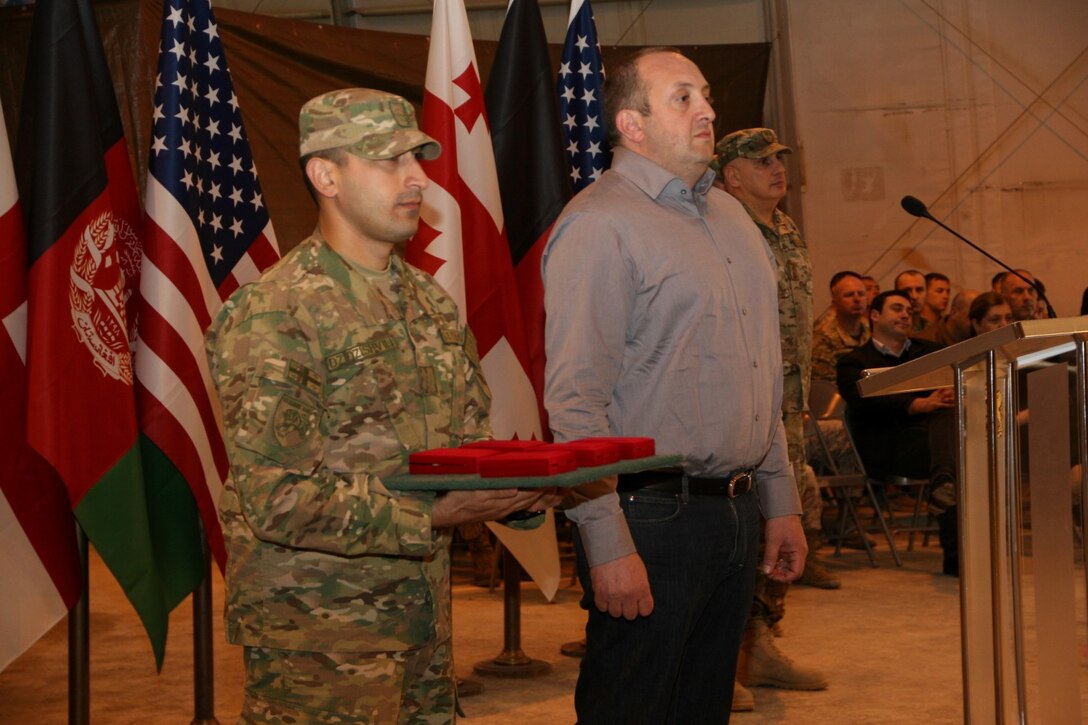 Georgian President Giorgi Margvelashvili prepares to present medals to soldiers with the 31st Light Infantry Battalion from the Republic of Georgia and U.S. Marines with Georgian Liaison Team 11 during his visit to Camp Leatherneck, Helmand province, Afghanistan, March 15, 2014. President Margvelashvili presented the awards to show his appreciation for the outstanding work the Georgians and Marines have accomplished.