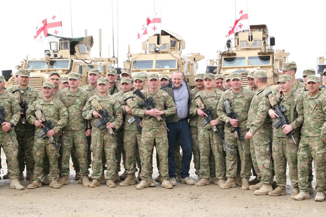 Georgian President Giorgi Margvelashvili, center, stands with soldiers with the 31st Light Infantry Battalion from the Republic of Georgia during his visit to Camp Leatherneck, Helmand province, Afghanistan, March 15, 2014. During his visit, he presented numerous awards to his soldiers as well as several Marines with Georgian Liaison Team 11 to show his appreciation for the outstanding work the Georgians and Marines have accomplished.