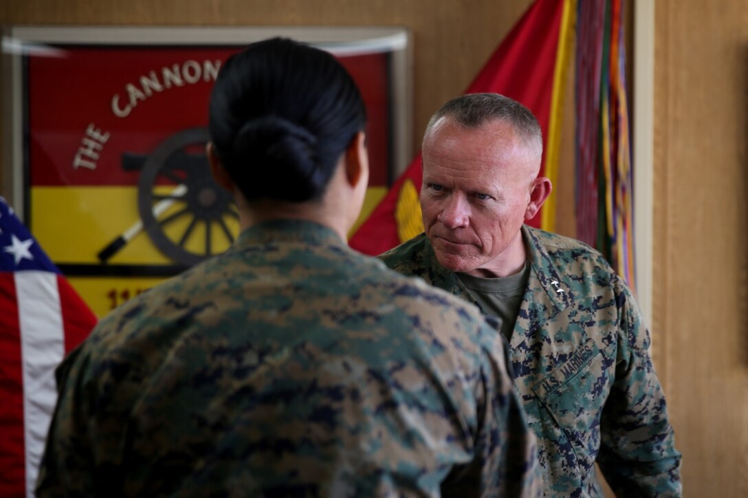 Major Gen. Lawrence Nicholson, commanding general of 1st Marine Division, congratulates 1st Lt. Thuymi Dinh, communications officer, 1st Battalion, 11th Marine Regiment on earning the Camp Pendleton female athlete of the year award at Marine Corps Base Camp Pendleton, Calif., Feb. 10, 2014. Dinh, a native of Anaheim, Calif., has participated in numerous triathlons and says she hopes to one day complete an ironman triathlon. Dinh also was a runner up in the Marine Corps female athlete of the year award. She will deploy to Afghanistan in support of Operation Enduring Freedom later this year.