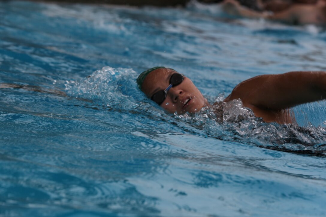 First Lt. Thuymi Dinh, communications officer, 1st Battalion, 11th Marine Regiment, swims laps as part of her training for triathlons at Camp Las Pulgas, Marine Corps Base Camp Pendleton, Calif., March 13, 2014. Dinh, a native of Anaheim, Calif., is being recognized as Camp Pendleton's Female Athlete of the Year. Dinh has competed in approximately 12 triathlons and hopes to one day compete in an Ironman Triathlon.