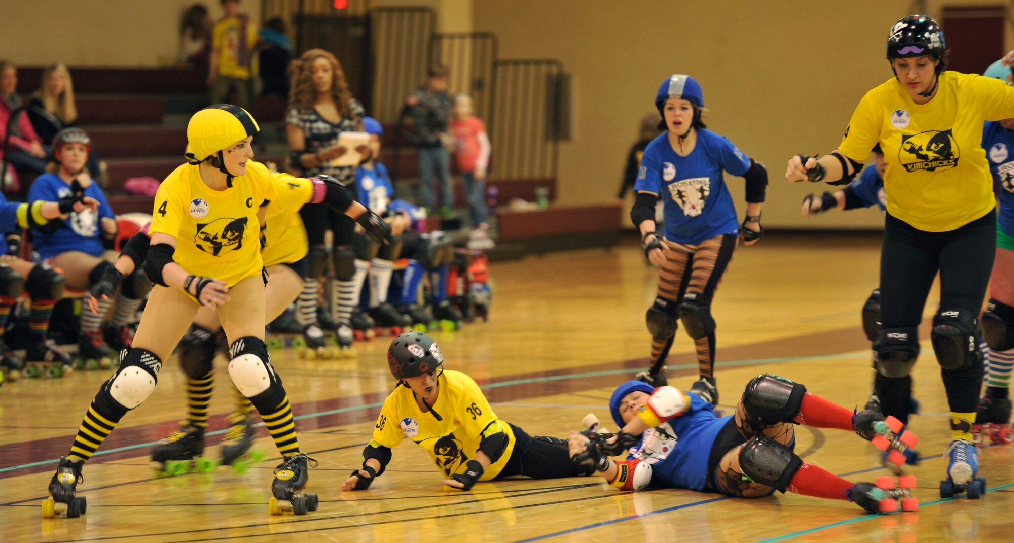 Members of the KimChicks and Rokettes roller derby teams engage each other during a bout at U.S. Army Garrison Humphreys, Republic of Korea, March 8, 2014. Both teams are primarily made up of active duty military members and spouses from Osan and Humphreys, who compete during monthly bouts. (U.S. Air Force photo/Senior Airman Siuta B. Ika)