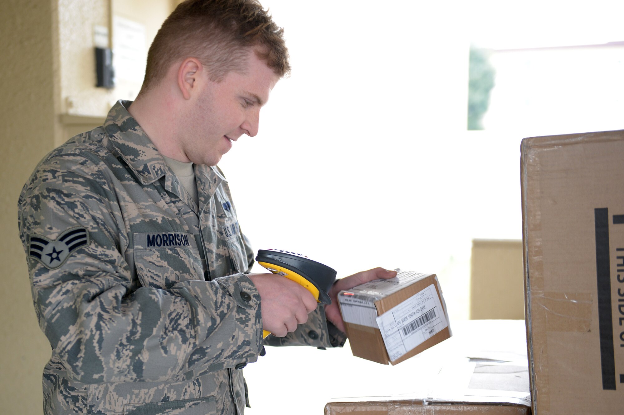 Senior Airman Christopher Morrison, 36th Airlift Squadron loadmaster, scans barcodes at Yokota Air Base, Japan, March 19, 2014. The barcodes are used to track mail coming from overseas, maintaining constant accountability for the mail. (U.S. Air Force photo by Airman 1st Class David Danford/Released)