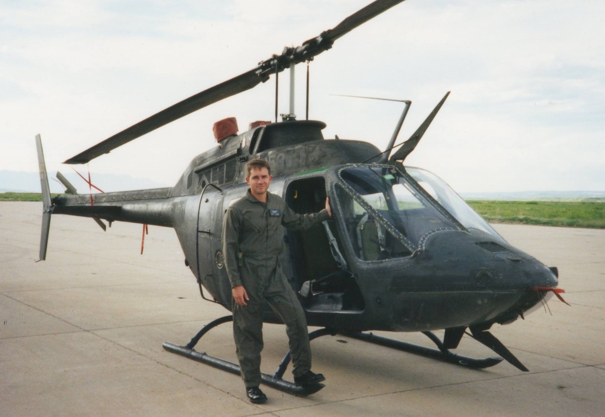 Chief Warrant Officer 1 Steven Lott stands by an OH-58 scout helicopter. Lott went to flight school from 1992 to 1993. In 1995, Lott transitioned to fixed wing aircraft. (Courtesy photo)