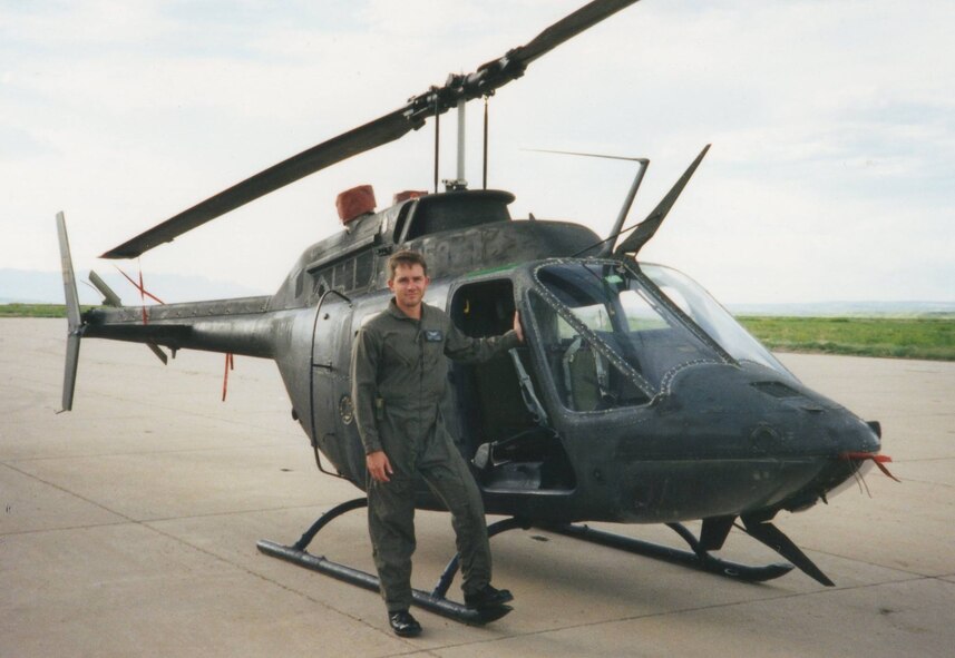 Chief Warrant Officer 1 Steven Lott stands by an OH-58 scout helicopter. Lott went to flight school from 1992 to 1993. In 1995, Lott transitioned to fixed wing aircraft. (Courtesy photo)