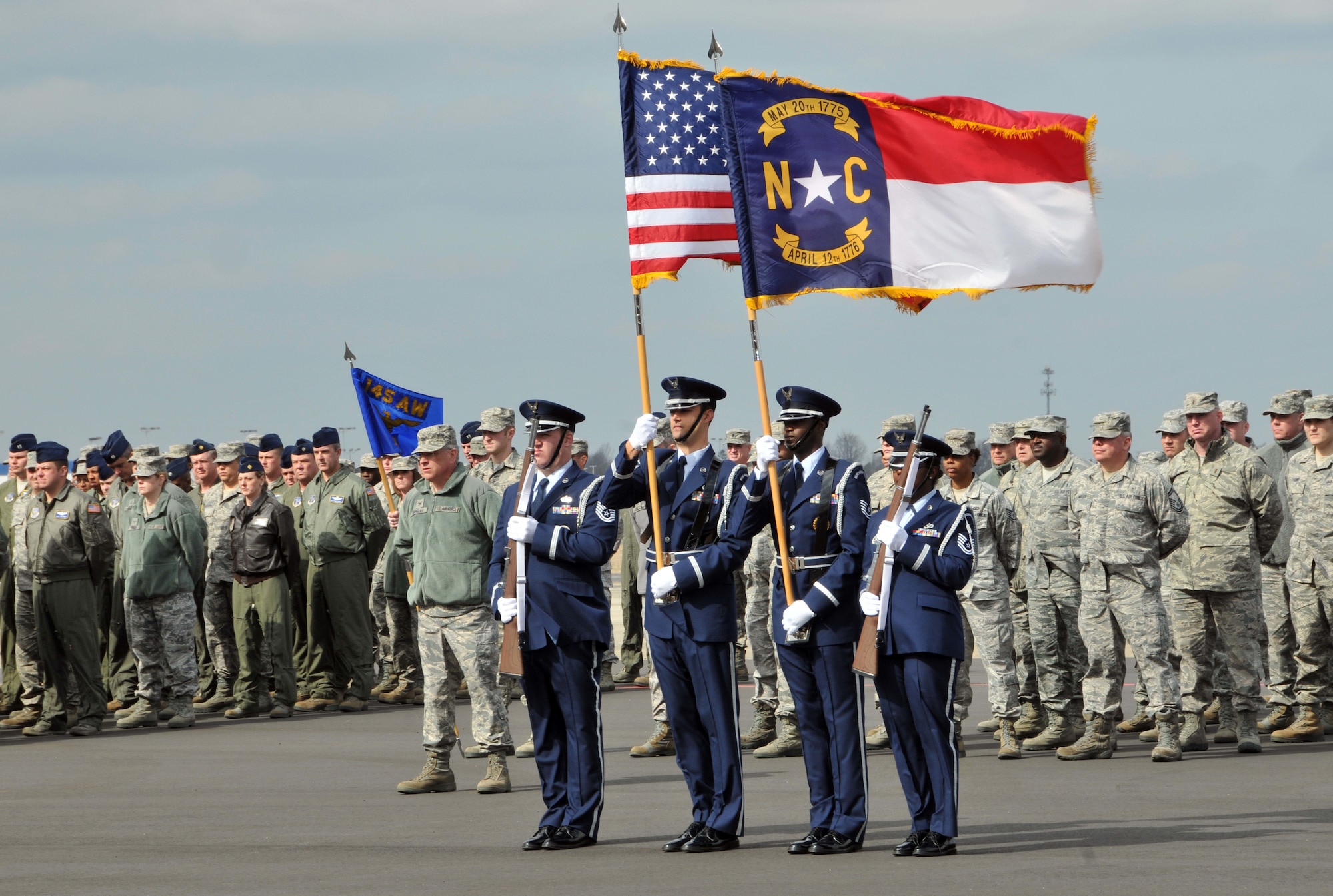 With polish and precision members of the 145th Airlift Wing’s Honor Guard conduct a traditional task of escorting the national and state flag and posting the colors in front of airmen standing in formation at the quarterly commander’s call held at the North Carolina Air National Guard base, Charlotte Douglas Intl airport, February 9, 2014. (U.S. Air National Guard photo by Senior Airman Laura Montgomery, 145th Public Affairs/Released)