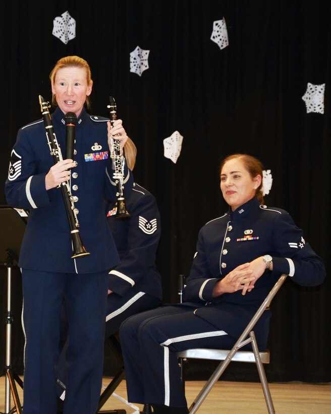 Master Sergeant Christy Bailes explains the difference between her smaller E-flat clarinet, right, and "regular" or B-flat clarinet, left, at an educational outreach school performance in January, 2014 in Elk Grove, CA. The "Wild West Winds" clarinet quartet, members of the Air Force Band of the Golden West stationed at Travis Air Force Base, California, spent a week performing for schools in the base's area. 