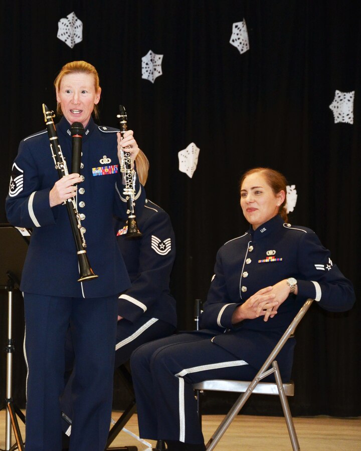Master Sergeant Christy Bailes explains the difference between her smaller E-flat clarinet, right, and "regular" or B-flat clarinet, left, at an educational outreach school performance in January, 2014 in Elk Grove, CA. The "Wild West Winds" clarinet quartet, members of the Air Force Band of the Golden West stationed at Travis Air Force Base, California, spent a week performing for schools in the base's area. 