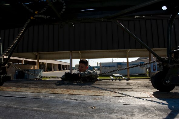 Airman 1st Class Benjamin Donahue, 1st Special Operations Logistics Readiness Squadron vehicle operator, secures an aircraft stand on a trailer on the flightline at Hurlburt Field, Fla., March 20, 2014. Donahue has been a vehicle operator for two months. (U.S. Air Force photo/Senior Airman Naomi Griego)