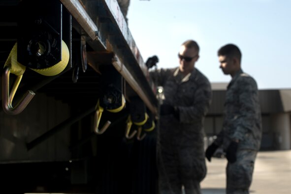 Staff Sgt. Gregory Laing and Airman 1st Class Benjamin Donahue, 1st Special Operations Logistics Readiness Squadron vehicle operators, secure an aircraft stand on a trailer on the flightline at Hurlburt Field, Fla., March 20, 2014. Laing instructed Donahue on how to operate the forklift. (U.S. Air Force photo/Senior Airman Naomi Griego)