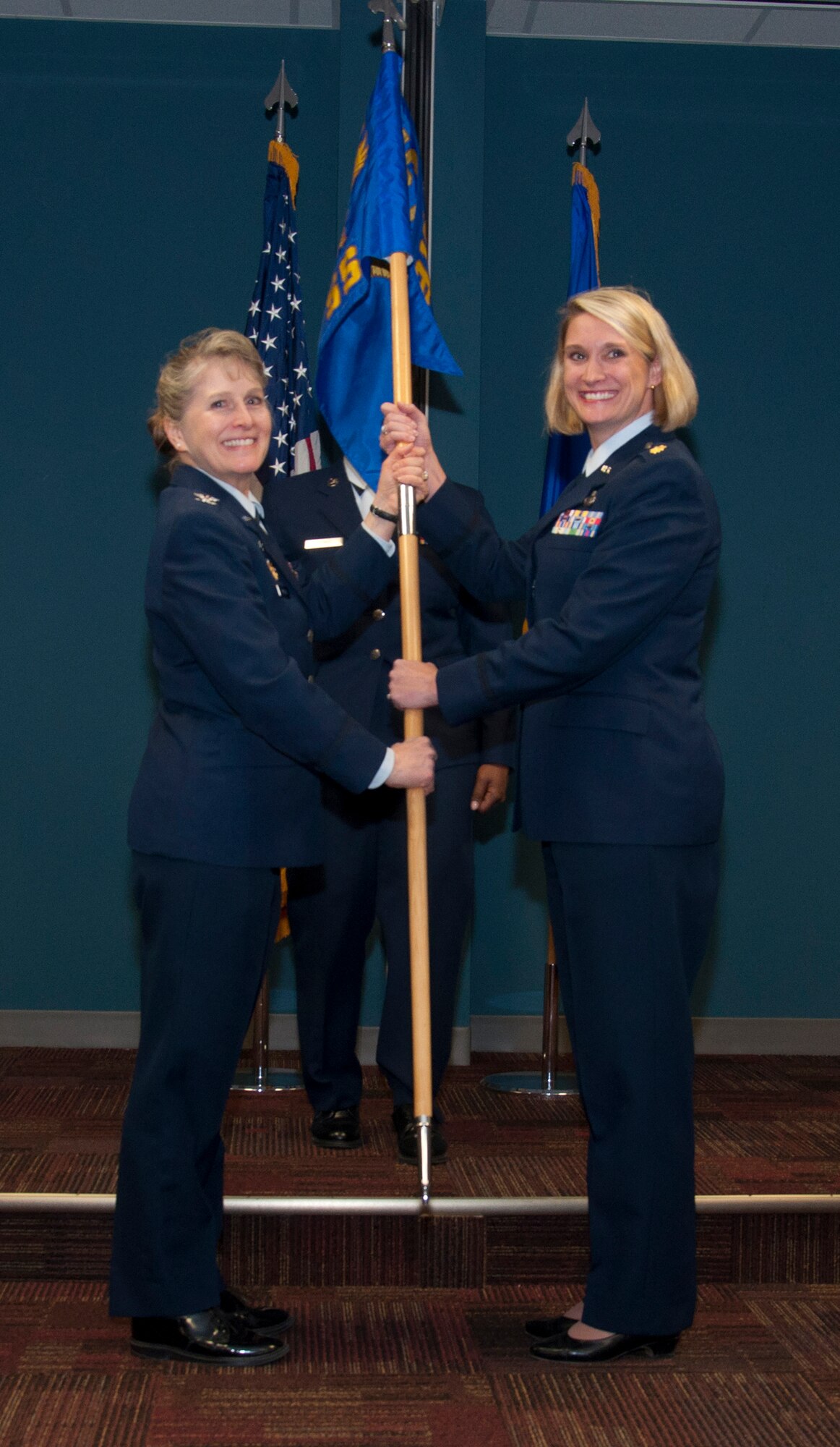 Col. Karen Magnus, 916th Mission Support Group commander, presents the 916th Force Support Squadron guidon to Maj. Shannon Mann. Mann assumed command of the FSS during a ceremony at Seymour Johnson Air Force Base, N.C., February 2014. (U.S. Air Force photo by Staff Sgt. Alan Abernethy, 916th ARW/PA)