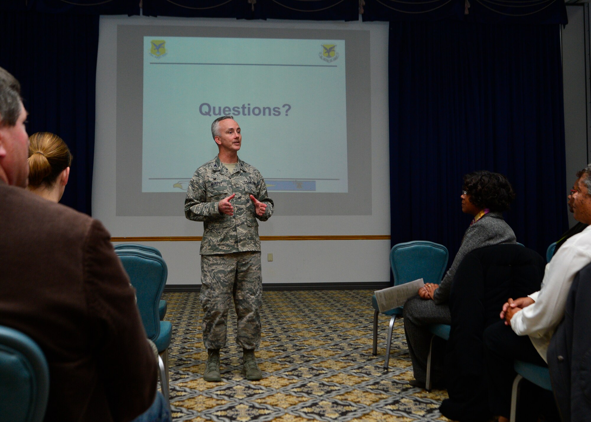 Col. Kevin Murphy, 436th Medical Group commander, answers questions during a town hall meeting about Tricare Service Centers closing March 19, 2014, at The Landings on Dover Air Force Base, Del. The Department of Defense will save $52 million this year alone by closing the service centers and offering the services online or by telephone. (U.S. Air Force photo/Airman 1st Class William Johnson)