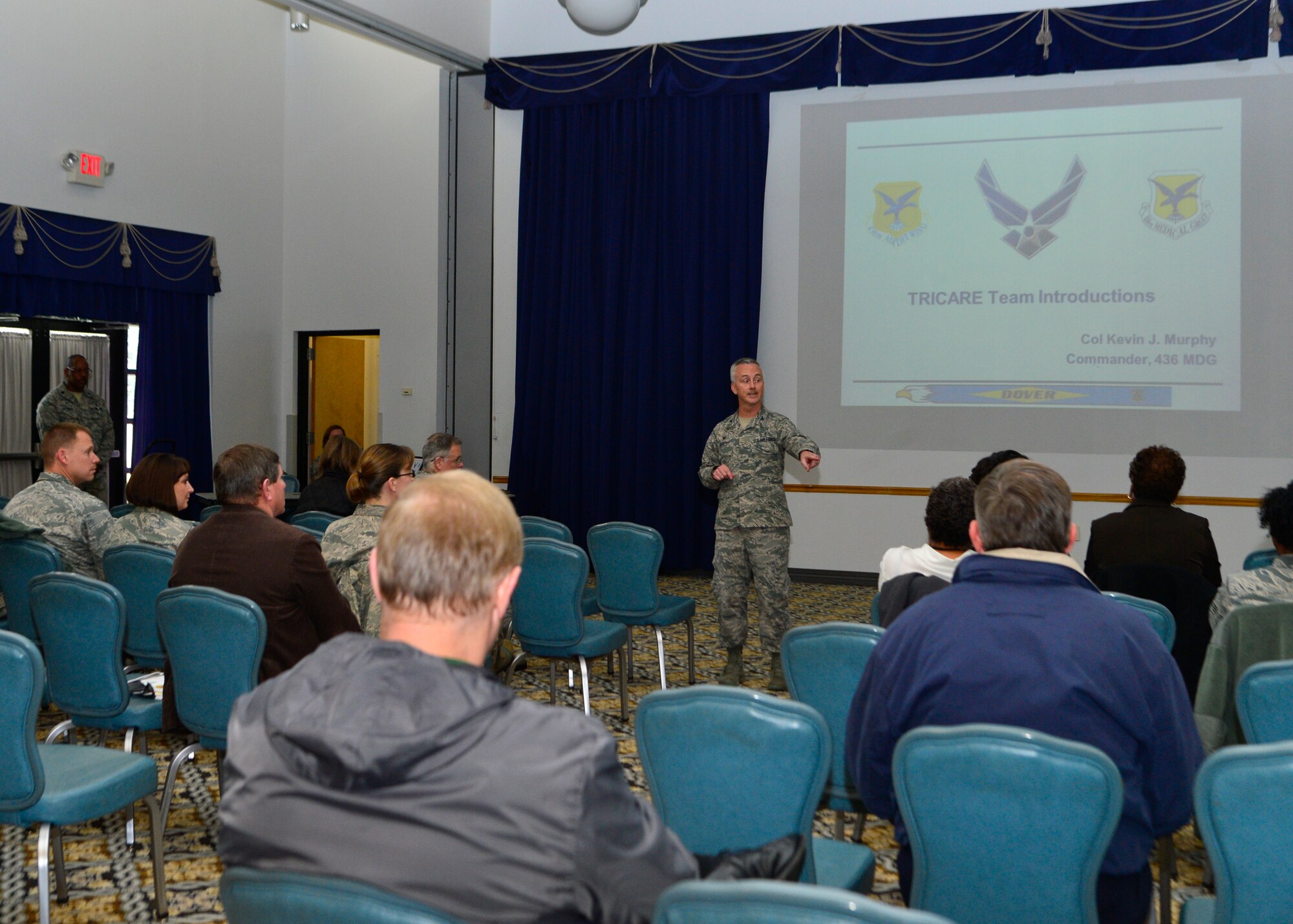 Col. Kevin Murphy, 436th Medical Group commander, briefs members of Team Dover during a town hall meeting about Tricare Service Centers closing across the continental United States March 19, 2014, at The Landings on Dover Air Force Base, Del. All Tricare walk-in services will now be conducted online or by telephone service centers. (U.S. Air Force Photo/Airman 1st Class William Johnson)