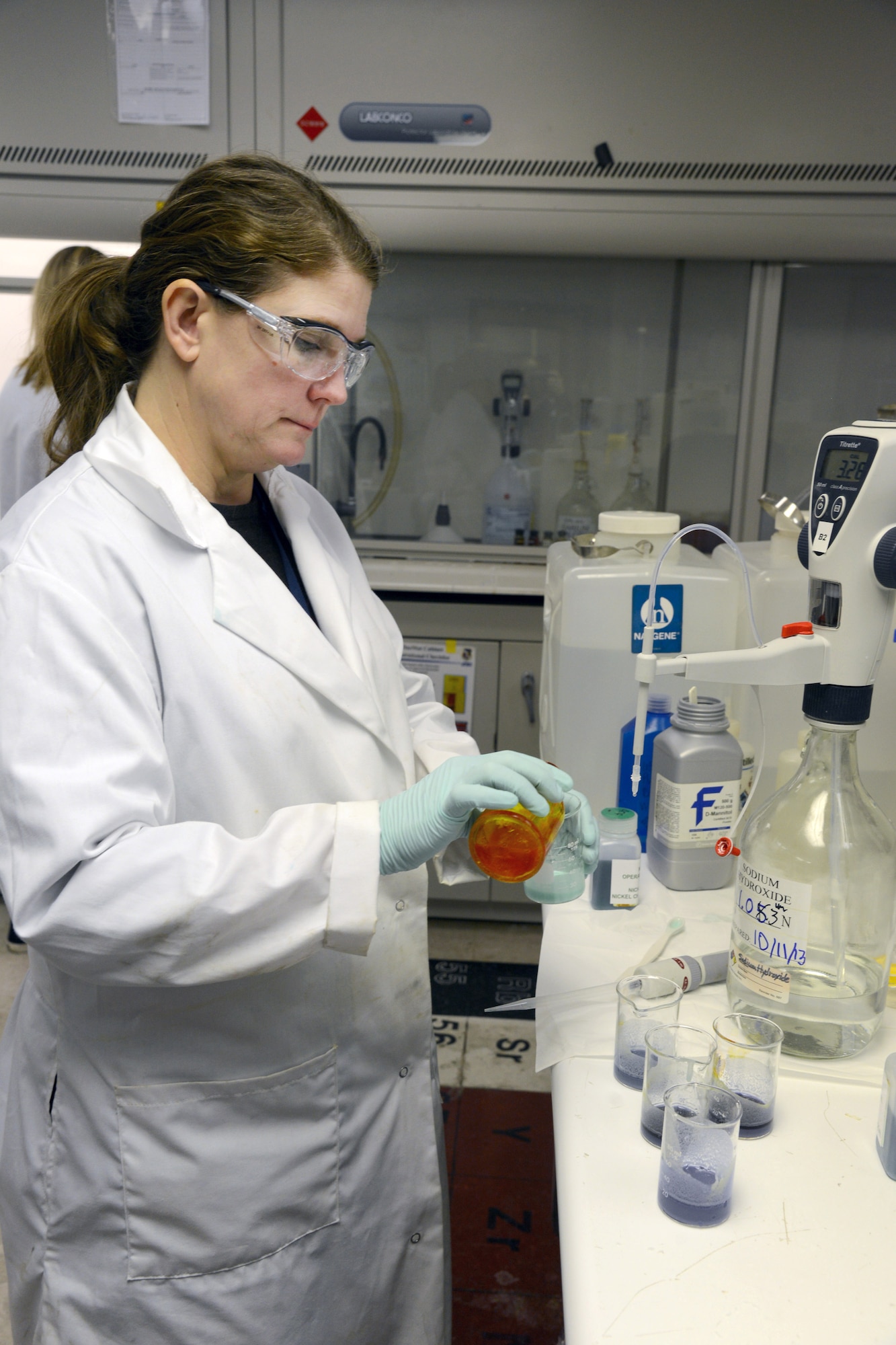 Sharla Clemenson, a chemist in the 76th Maintenance Support Squadron, performs an acid/base titration with a nickel electroplating solution. This kind of test is performed on every tank in the Plating Shop. The chemists test the quality of the solution and make recommendations based on their findings. (Air Force photo by Kelly White)