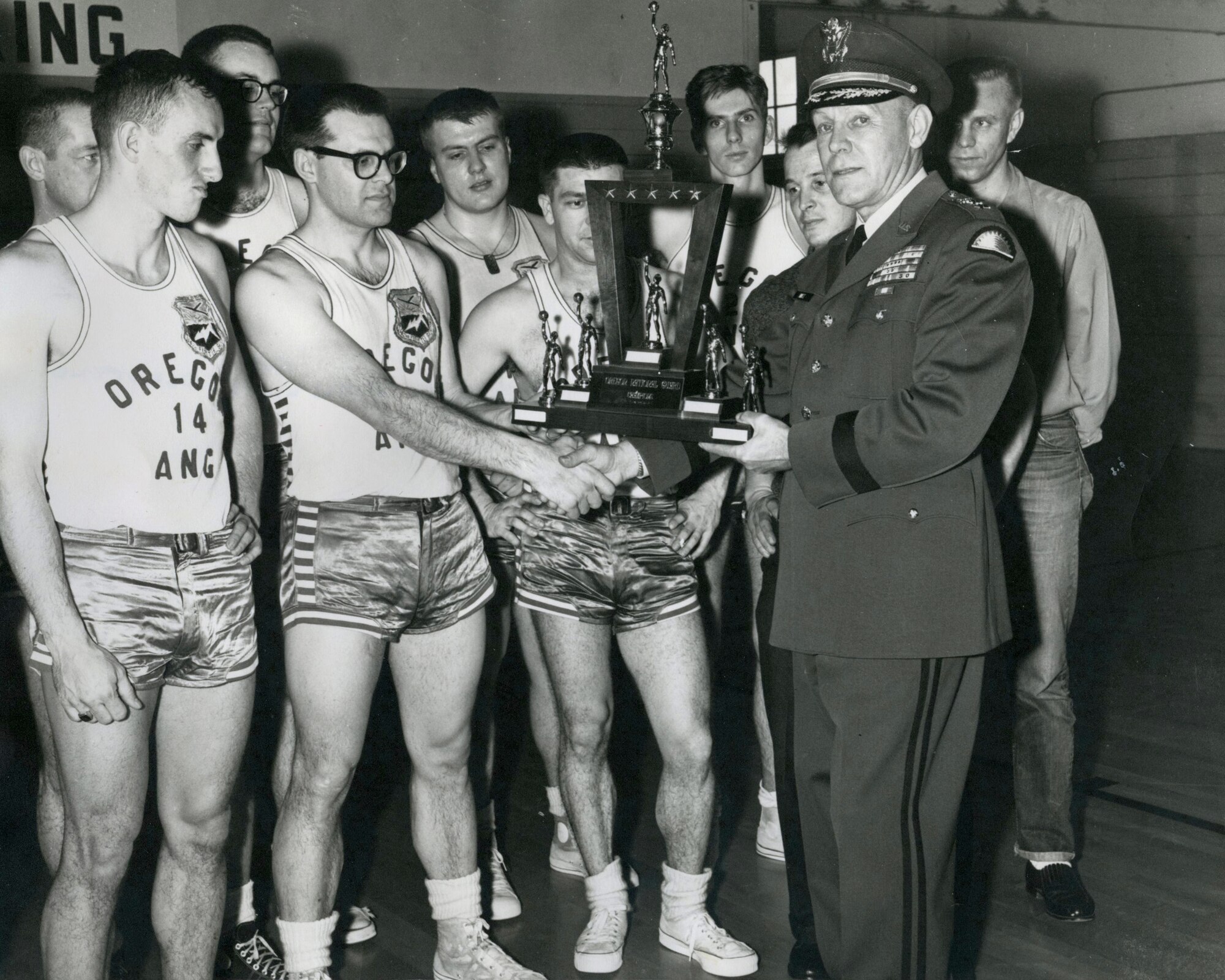 Maj.Gen. Alfred A. Hintz, The Adjutant General, presents the State Championship Trophy to the Oregon Air National Guard Champions in early 1961. (photo from the 142nd Fighter Wing History Department)
