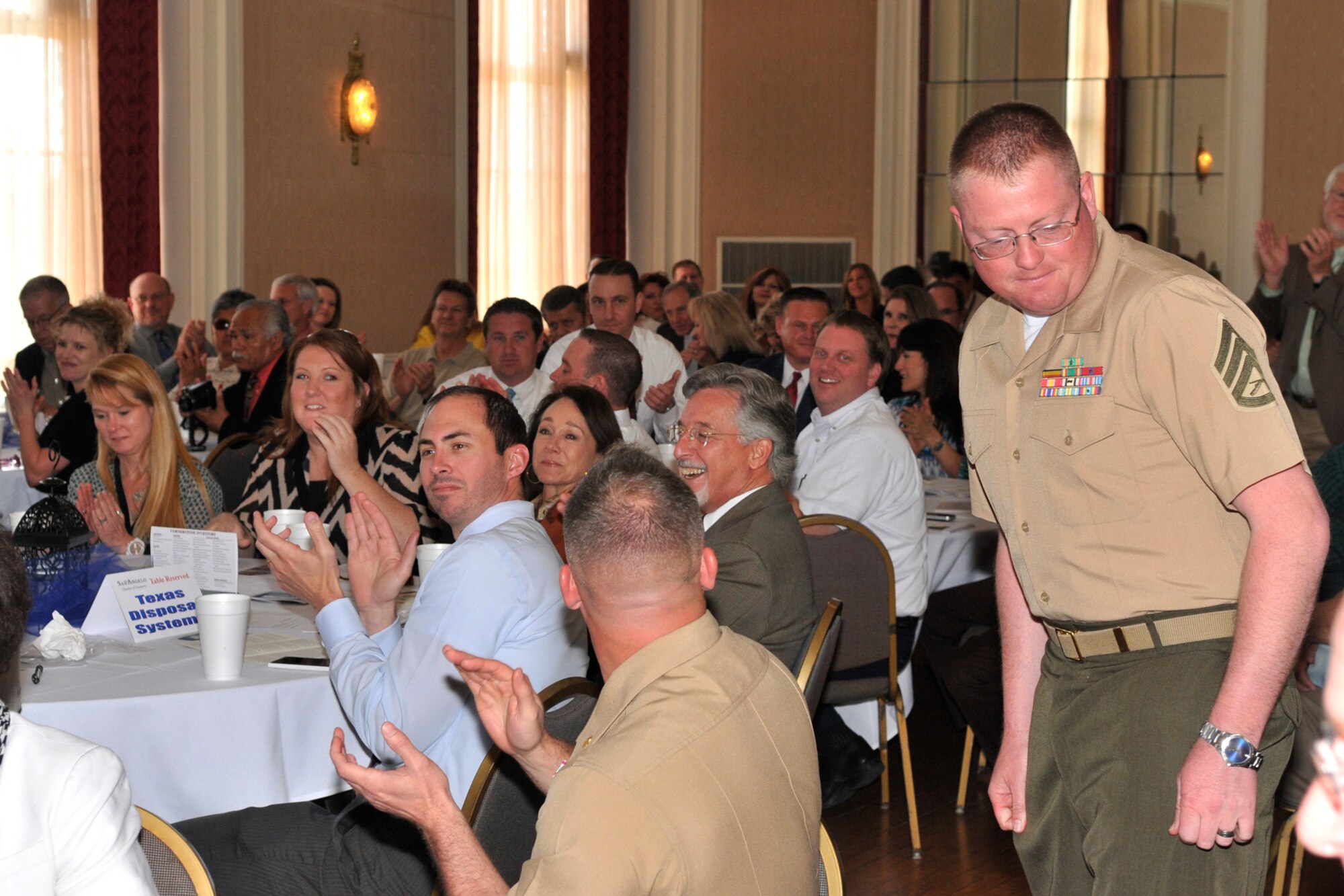 SAN ANGELO, Texas – Marine Corps Staff Sgt. DeWayne Meats, Marine Corps Detachment and Louis F. Garland DOD Fire Academy Crash Fire Rescue instructor, proceeds to the stage to receive the Order of Merit award at the Cactus Hotel March 11. The Order of Merit award was presented to Meats in recognition of his involvement with the community in San Angelo. (U.S. Air Force Photo/ Airman 1st Class Devin Boyer)