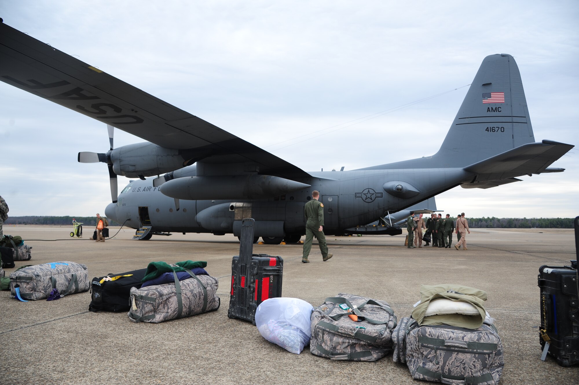 Redeployers from various squadrons unload their bags after returning from a deployment March 14, 2014, at Little Rock Air Force Base, Ark. The 61st AS C-130H was one of the last two H model aircraft from Little Rock AFB to return from supporting contingency operations in Southwest Asia. (U.S. Air Force photo by Senior Airman Kaylee Clark)