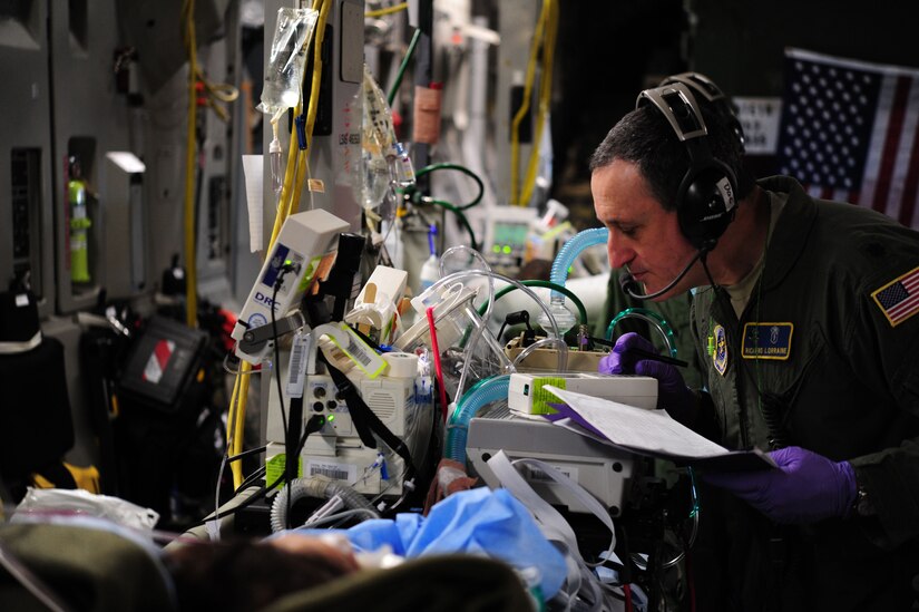 Lt. Col. Richard Lorraine cares for an intensive care patient during a flight back to Joint Base Andrews, Md., Dec. 19, 2013. Lorraine, a member of a Critical Care Air Transport Team belongs to the 111th Medical Group. (U.S. Air Force photo/Airman 1st Class Aaron Stout)   