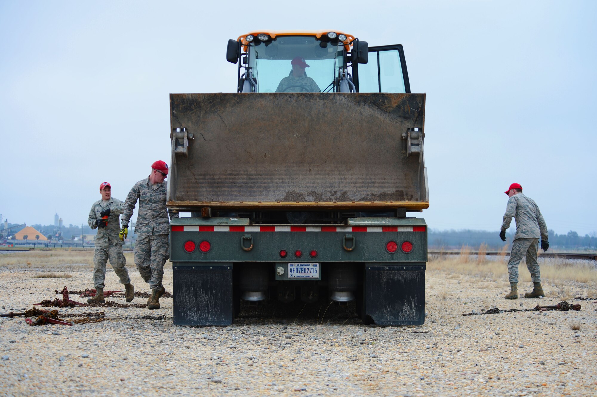 U. S. Air Force Airmen from 823rd RED HORSE assigned to Hurlburt Field, Fla., prepare a 426 wheel loader at Shaw Air Force Base, S.C., March 18, 2014. A total of 18 Airmen spent two days at Shaw unloading and preparing heavy equipment in preparation for a road pavement project to tear up and re-pave patrol road. (U.S. Air Force photo by Airman 1st Class Jensen Stidham/Released) )