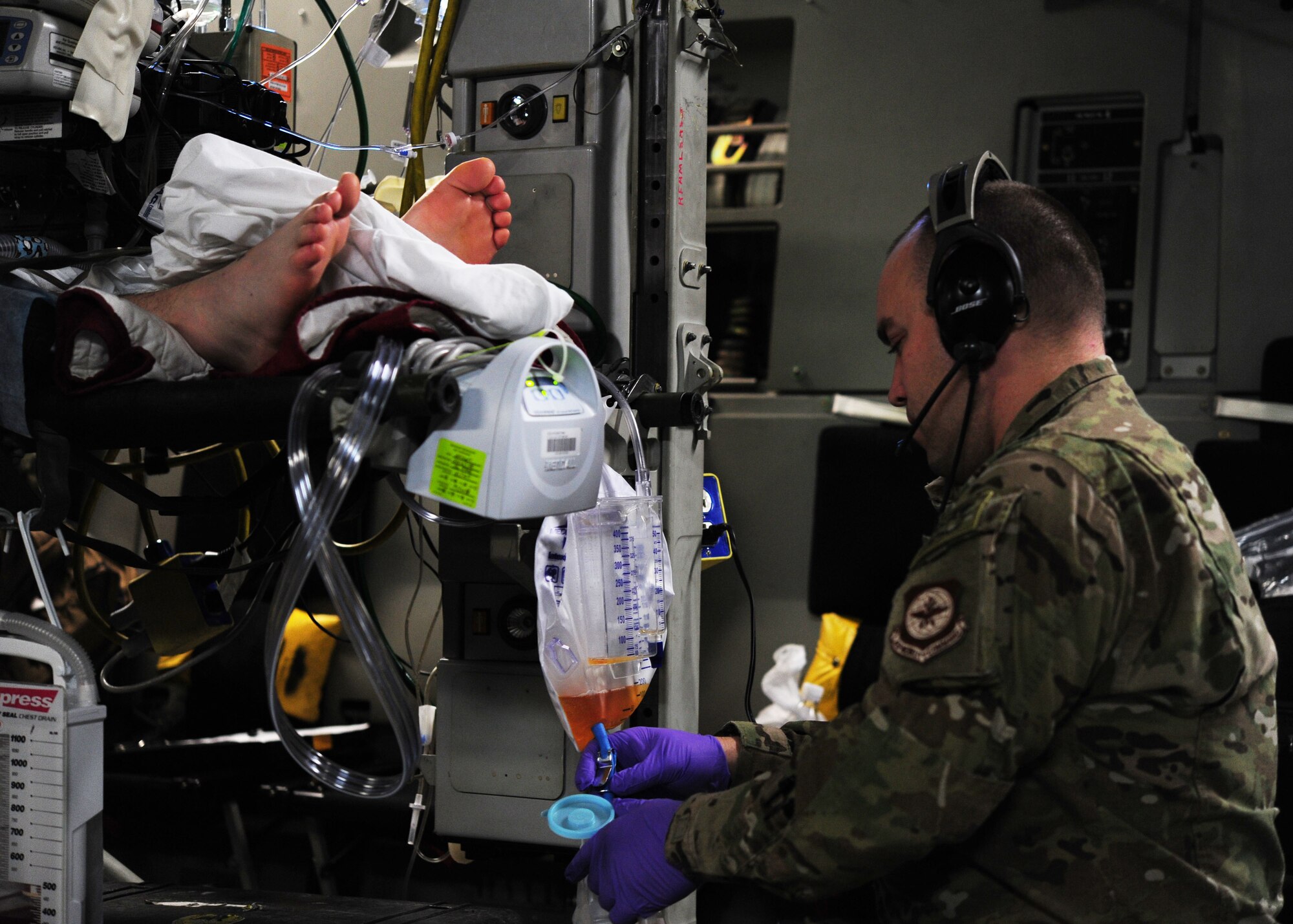 Maj. Shane Runyon tends to a critical care patient on an aeromedical evacuation mission from Bagram Air Base, Afghanistan, Dec. 16, 2013. Runyon is a critical care nurse deployed to the 10th Expeditionary Aeromedical Evacuation Flight Ramstein Air Base, Germany. (U.S. Air Force photo/Airman 1st Class Aaron Stout)