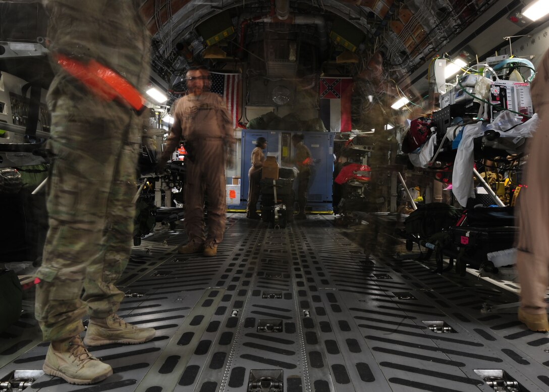 Medical personal with the 445th Aeromedical Evacuation Squadron and the 10th Expeditionary Aeromedical Evacuation Flight prepare patients for transport at Bagram Air Base, Afghanistan, Dec. 16, 2013. Sick and injured from combat zones are evacuated to Landstuhl Regional Medical Center, Germany for more secure care. (U.S. Air Force photo/Airman 1st Class Aaron Stout) 