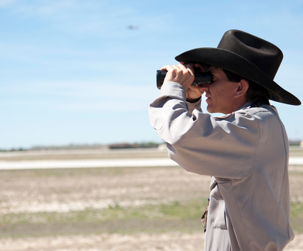 Dedrick Pesek, 47th Flying Training Wing Safety Office wildlife biologist, scans the flight line and surrounding areas for animals that could cause problems for pilots and aircrafts on Laughlin Air Force Base, Texas, March 18, 2014. Since November 2013, Laughlin has only had one run in with birds causing damage to an aircraft. (U.S. Air Force photo/Airman 1st Class Jimmie D. Pike)