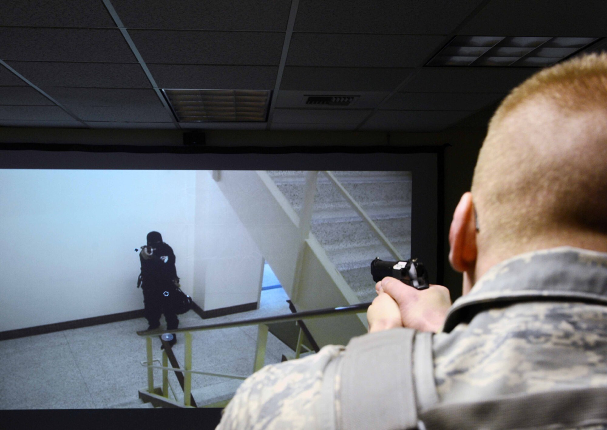 JOINT BASE ELMENDORF-RICHARDSON-- . The annual use of force training is performed by all 673d Security Forces Squadron and consist of written test assessments, instructional videos and active-shooter training using the MILO Range simulator. (U.S. Air Force photo/Airman 1st Class Ty-Rico Lea)
