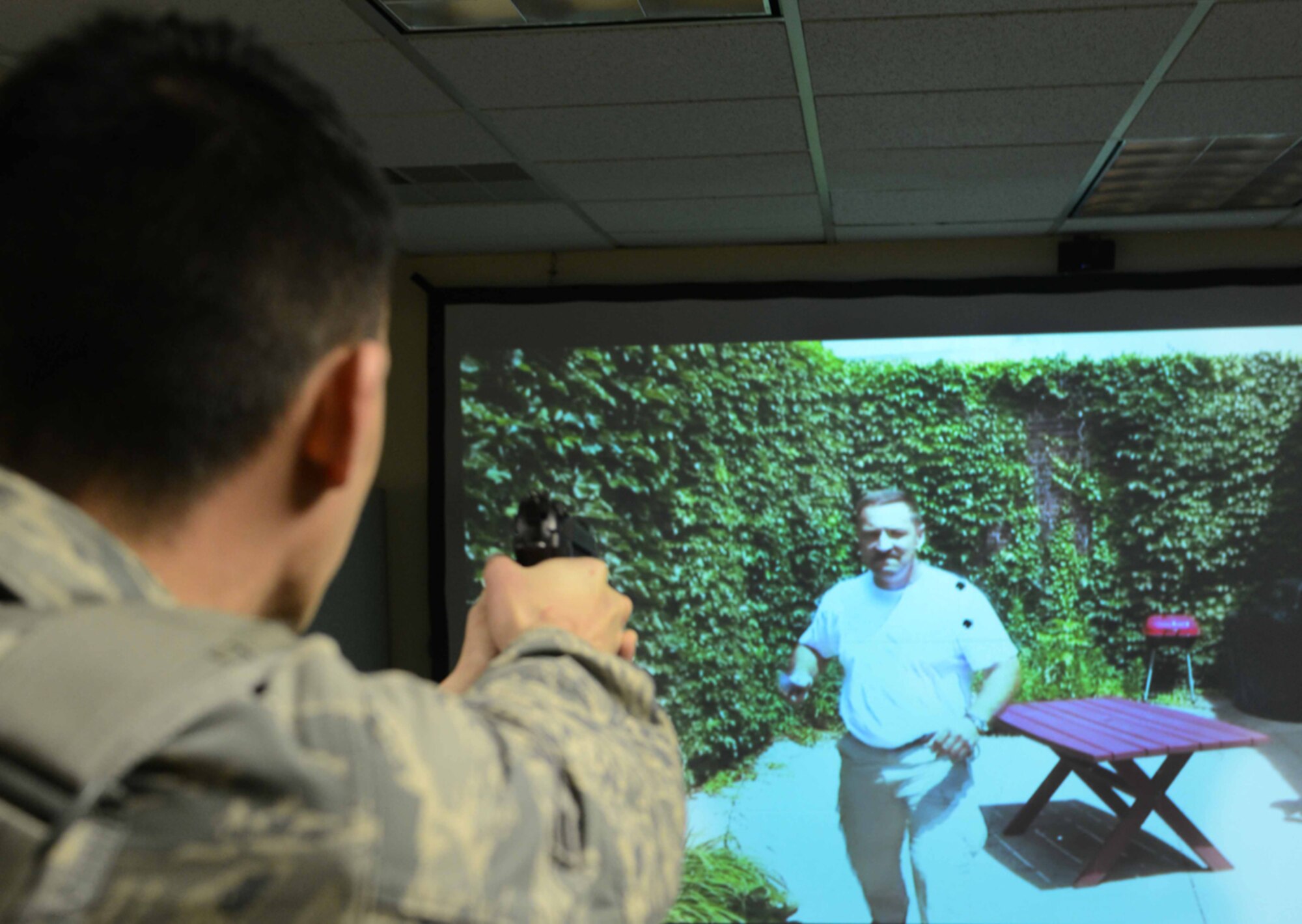 JOINT BASE ELMENDORF-RICHARDSON-- . The annual use of force training is performed by all 673d Security Forces Squadron and consist of written test assessments, instructional videos and active-shooter training using the MILO Range simulator. (U.S. Air Force photo/Airman 1st Class Ty-Rico Lea)