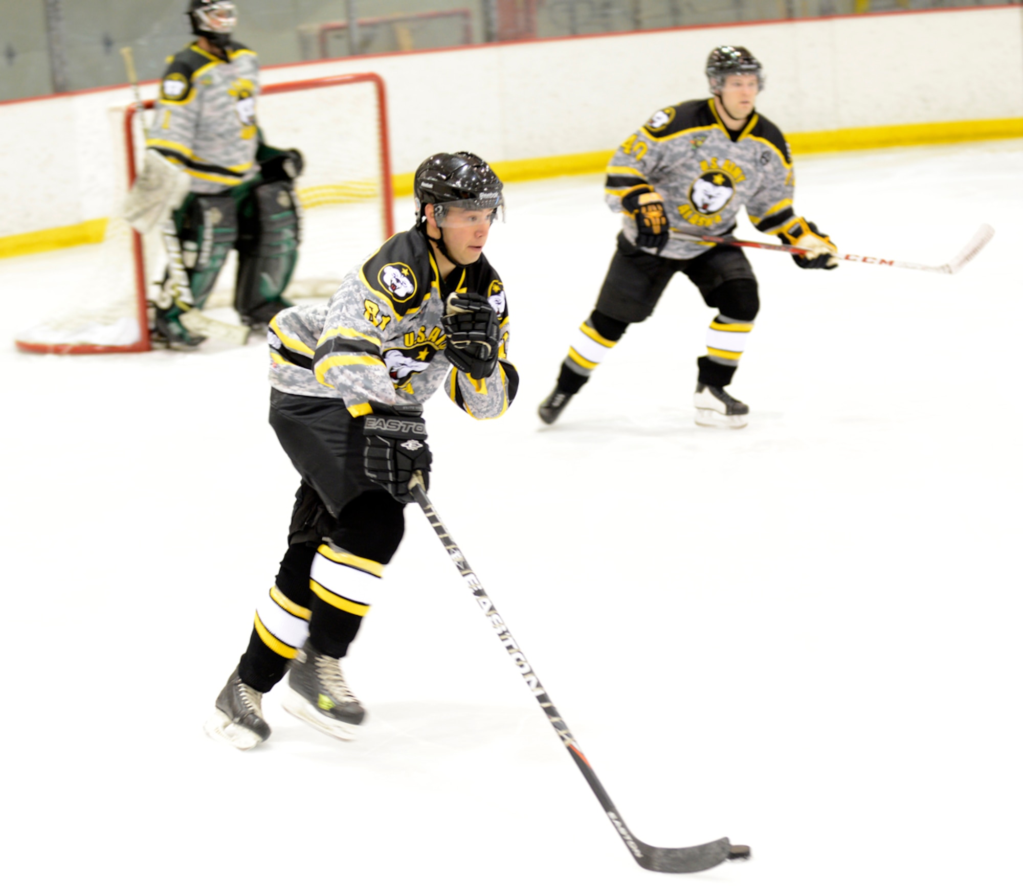 JOINT BASE ELMENDORF-RICHARDSON, Alaska – Adam Crowley, 1st Squadron (Airborne), 40th Cavalry Regiment, 4th Brigade Combat Team (Airborne), 25th Infantry Division, handles the puck during the first Air Force vs. Army hockey game at the Wells Fargo Sports Complex on the University of Alaska Anchorage campus March 15. The game promoted esprit de corps and enhanced the relationship between Joint Base Elmendorf-Richardson and the Anchorage community. The Air Force team won the game five to four. (U.S. Air Force photo/Staff Sgt. Blake Mize)