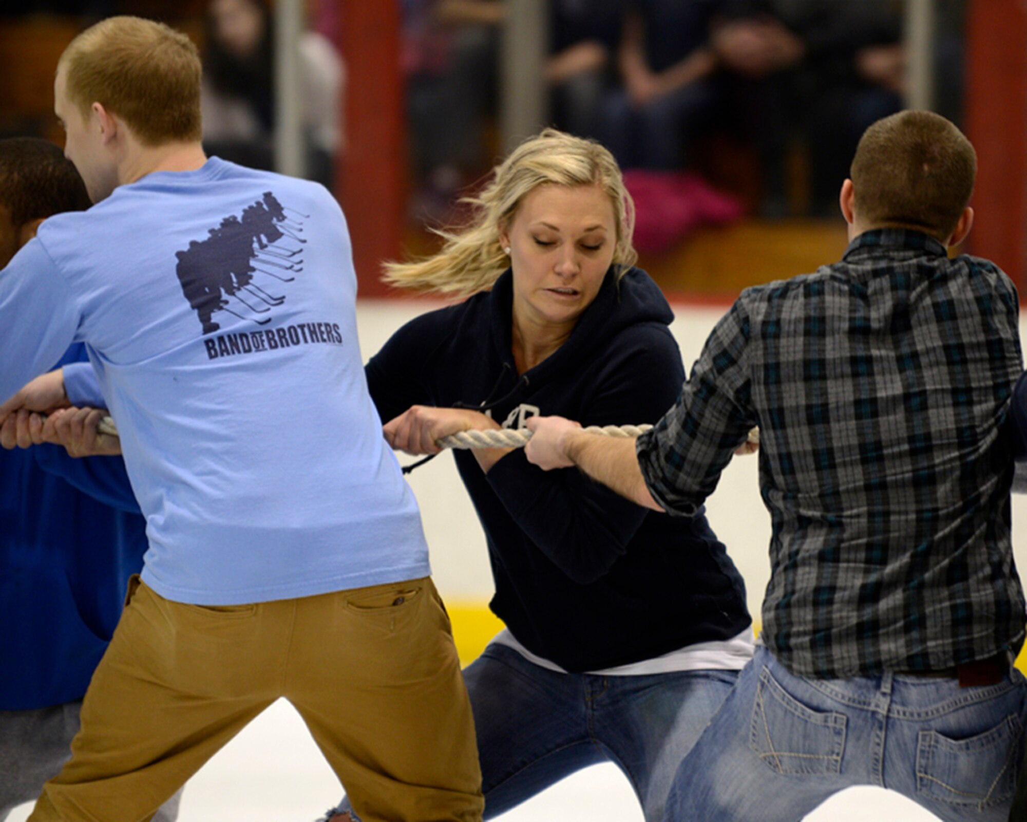 JOINT BASE ELMENDORF-RICHARDSON, Alaska – Julia Varga, 673d Force Support Squadron, and her fellow Airmen compete in a tug-of-war during intermission of the first Air Force vs. Army hockey game at the Wells Fargo Sports Complex on the University of Alaska Anchorage campus March 15. The game promoted esprit de corps and enhanced the relationship between Joint Base Elmendorf-Richardson and the Anchorage community. The Air Force team won the game five to four. (U.S. Air Force photo/Staff Sgt. Blake Mize)