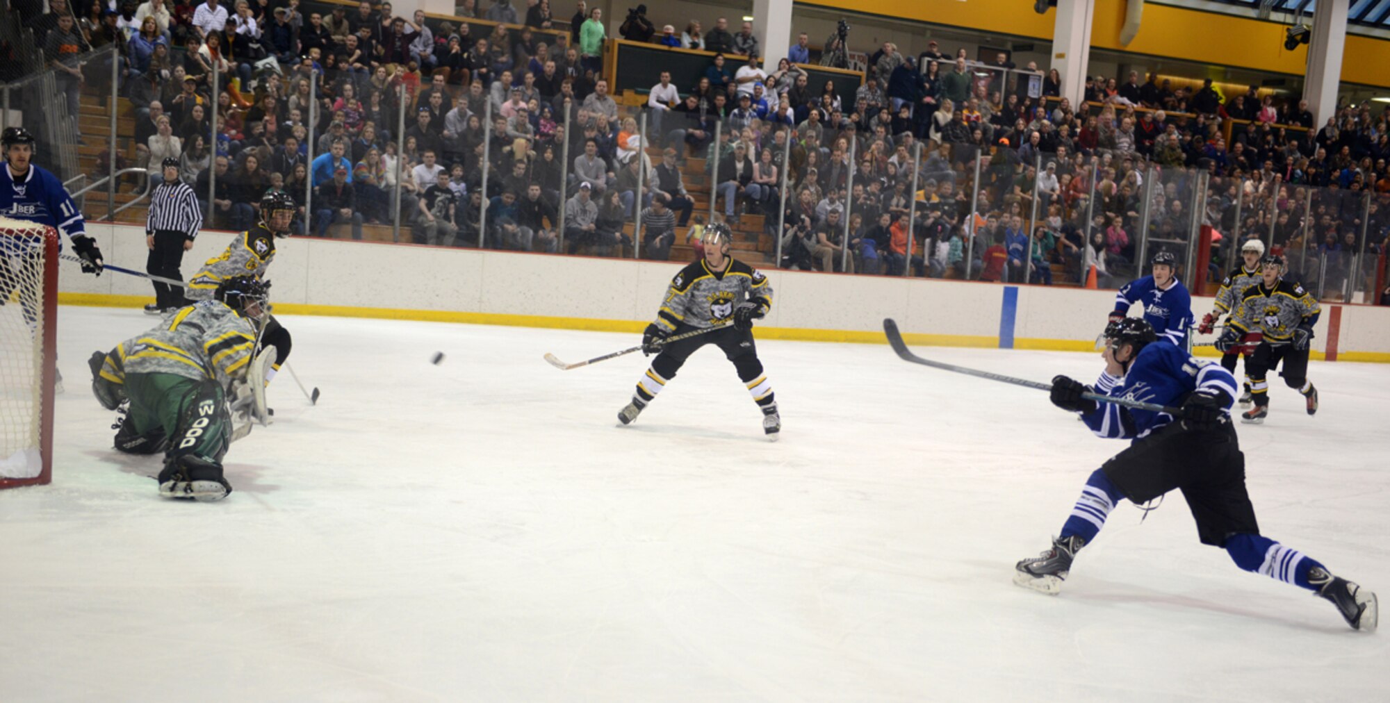 JOINT BASE ELMENDORF-RICHARDSON, Alaska – Sam Holl, 673d Force Support Squadron, takes a shot during the first Air Force vs. Army hockey game at the Wells Fargo Sports Complex on the University of Alaska Anchorage campus March 15. The game promoted esprit de corps and enhanced the relationship between Joint Base Elmendorf-Richardson and the Anchorage community. The Air Force team won the game five to four. (U.S. Air Force photo/Staff Sgt. Blake Mize)