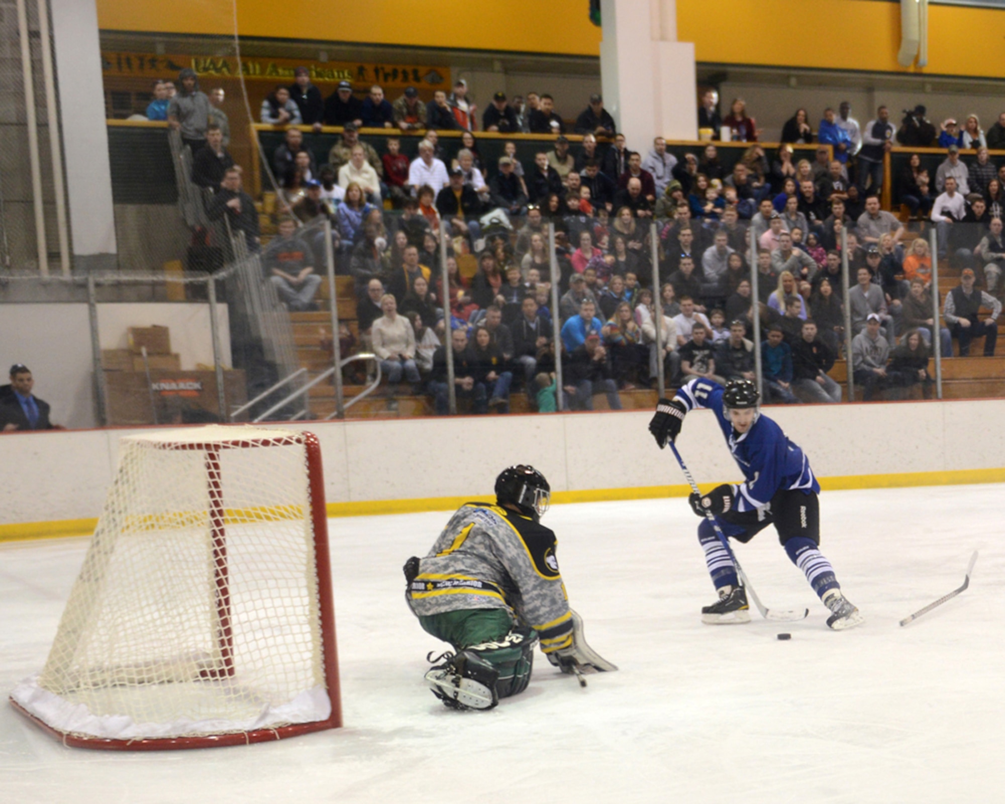 JOINT BASE ELMENDORF-RICHARDSON, Alaska – Jacques Lamoureux, 673d Contracting Squadron, prepares to score the winning goal during the first Air Force vs. Army hockey game at the Wells Fargo Sports Complex on the University of Alaska Anchorage campus March 15. The game promoted esprit de corps and enhanced the relationship between Joint Base Elmendorf-Richardson and the Anchorage community. Lamoureux’s third-period goal was the Air Force team’s fifth in a five to four win. (U.S. Air Force photo/Staff Sgt. Blake Mize)