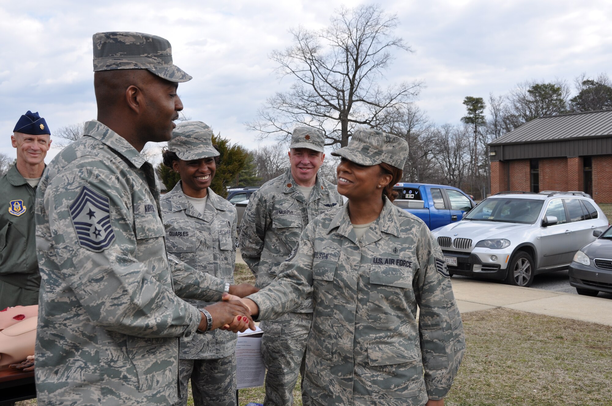 Command Chief Master Sergeant Cameron B. Kirksey, Air Force Reserve Command, Robins Air Force Base, Ga., coins Staff Sgt. Karin Nelson, Aeromedical Staging Squadron medical technician, during a block training at Joint Base Andrews, Md., March 15, 2014, for being a progressive member of her unit and a leader in the Rising Six council at. Kirksey spent the day with members of the 459th Air Refueling Wing to gain first-hand insight on daily operations throughout the wing. (U.S. Air Force photo/ Staff Sgt. Amber Russell)
