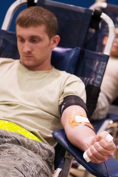 U.S. Air Force Airman 1st Class Korey Kelley, 23d Equipment Maintenance Squadron non-destructive inspection journeyman, donates blood at the Freedom 1 Fitness Center at Moody Air Force Base, Ga., March 19, 2014. The event was hosted by Airmen Committed to Excellence in hopes of relieving the American Red Cross blood deficiency of 2,175 blood and platelet donations. (U.S. Air Force photo by Senior Airman Tiffany M. Grigg/Released) 