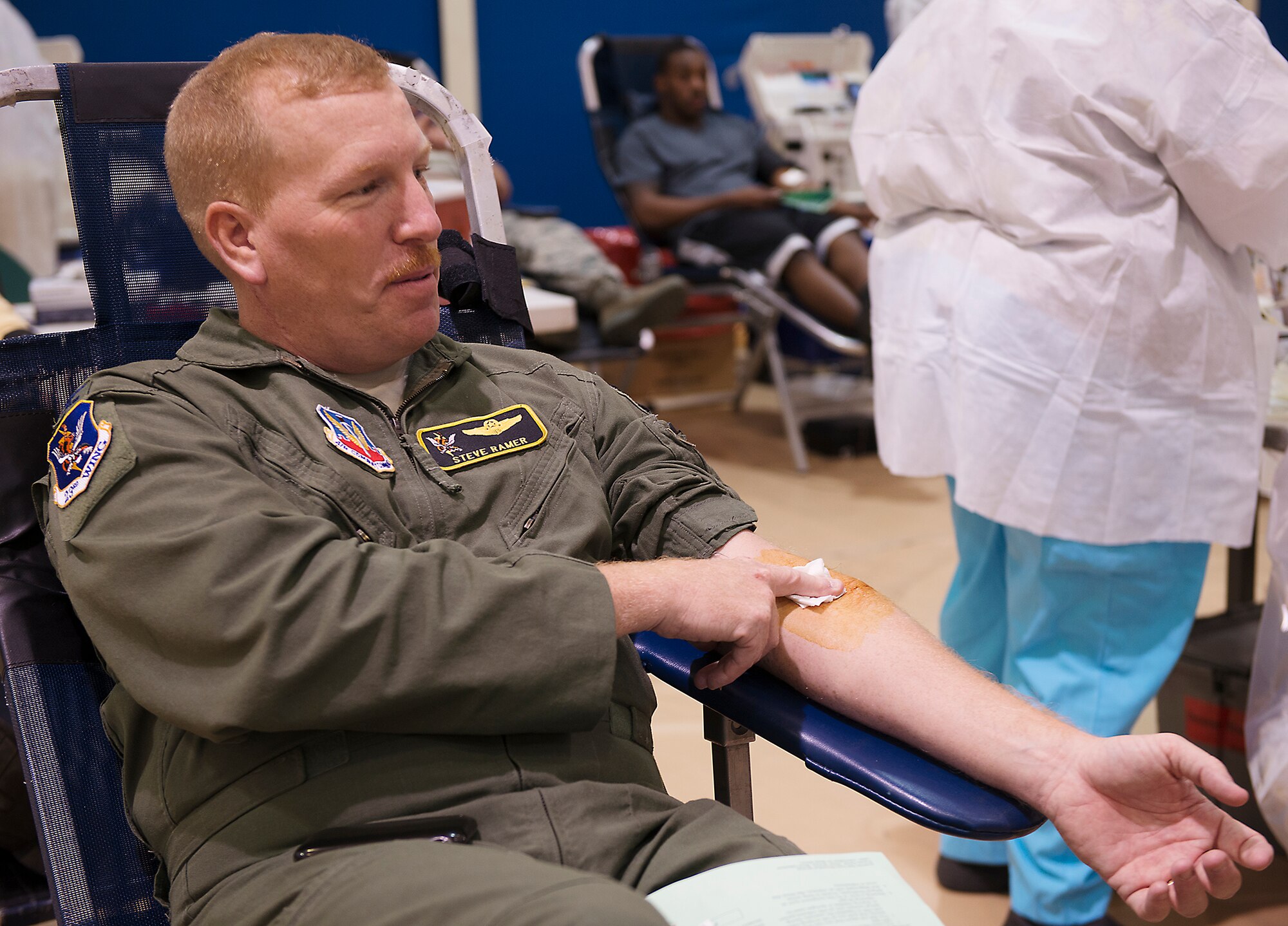 U.S. Air Force Col. Steven Ramer, 23d Wing vice commander, holds a bandage on his arm after donating blood at the Freedom 1 Fitness Center at Moody Air Force Base, Ga., March 19, 2014. The event, hosted by Airmen Committed to Excellence, was held to help the American Red Cross, which has suffered more than 600 blood drive cancellations across the U.S. due to bad weather conditions this year. (U.S. Air Force photo by Senior Airman Tiffany M. Grigg/Released) 
