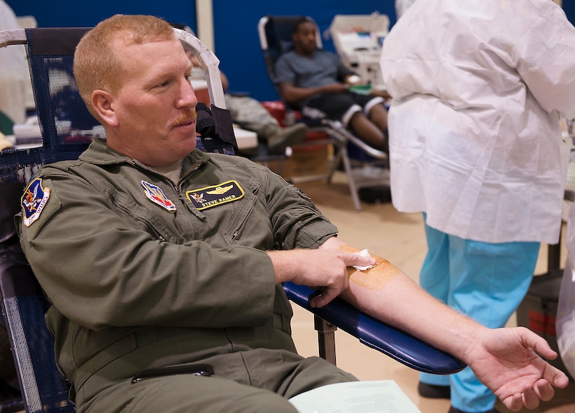U.S. Air Force Col. Steven Ramer, 23d Wing vice commander, holds a bandage on his arm after donating blood at the Freedom 1 Fitness Center at Moody Air Force Base, Ga., March 19, 2014. The event, hosted by Airmen Committed to Excellence, was held to help the American Red Cross, which has suffered more than 600 blood drive cancellations across the U.S. due to bad weather conditions this year. (U.S. Air Force photo by Senior Airman Tiffany M. Grigg/Released) 