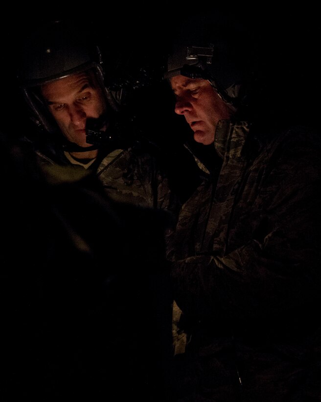 Loadmasters Senior Master Sgt. Mike Tracy, right, and Master Sgt. Tim McCann go through their checklist in St. Paul, Minn., Mar. 14, 2014.  They participated in an eight-ship C-130 Hercules interfly training mission. This training was a unique opportunity for both squadrons to share C-130 tactics and techniques in adverse weather conditions and wearing night-vision goggles in a low-level flying environment.
(U.S. Air National Guard photo by Tech. Sgt. Amy M. Lovgren/Released)
