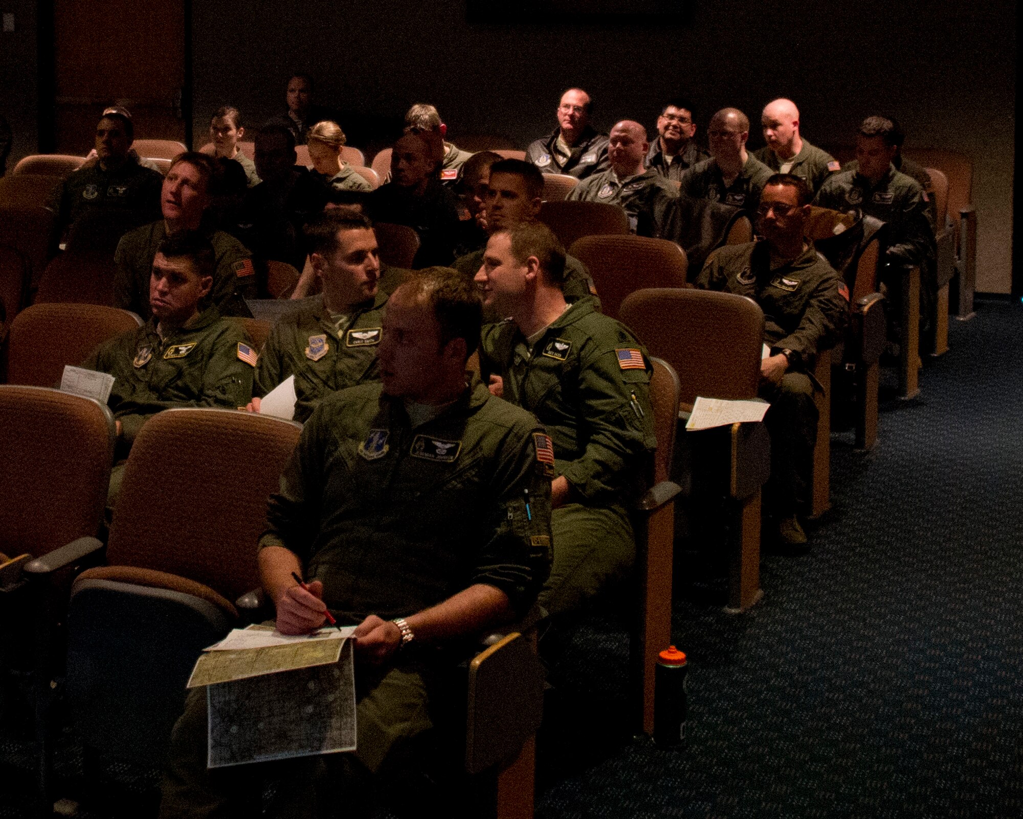 Airmen from the 109th Airlift Squadron and 96th Airlift Squadron listen to a mission briefing in St. Paul, Minn., Mar. 14, 2014. The Airmen participated in an eight-ship C-130 Hercules interfly training mission. This training was a unique opportunity for both squadrons to share C-130 tactics and techniques in adverse weather conditions and wearing night-vision goggles in a low-level flying environment.
(U.S. Air National Guard photo by Tech. Sgt. Amy M. Lovgren/Released)
