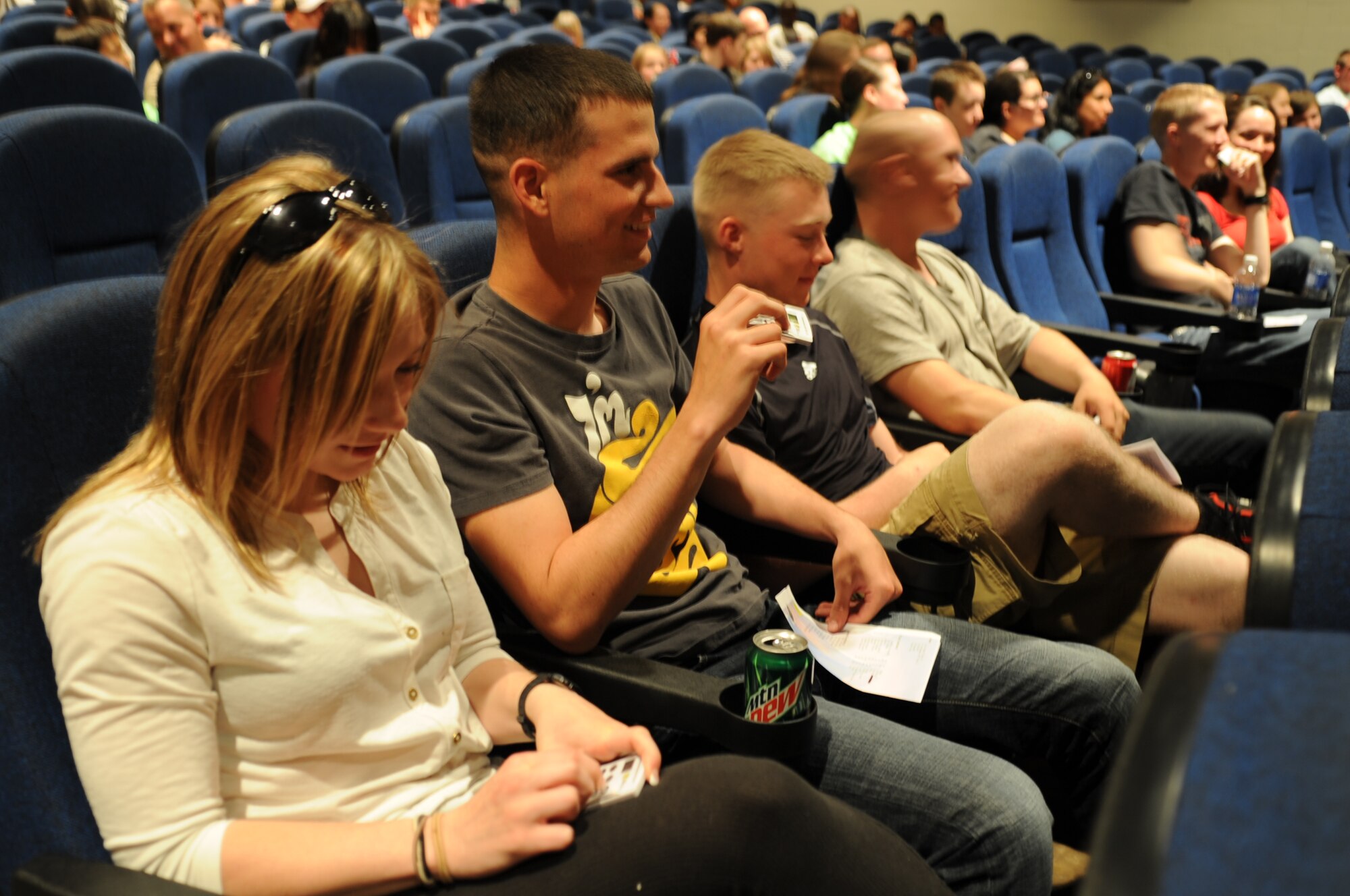 GOODFELLOW AIR FORCE BASE, Texas -- Students use voting machines to choose their favorite performer following the final round of the Student’s Got Talent competition at the Base Theater here March 11. The 17th Training Wing Chapel Office staff provided 100 voting machines and one-fifth of the points came from the audience. (U.S. Air Force photo/ Staff Sgt. Laura R. McFarlane)