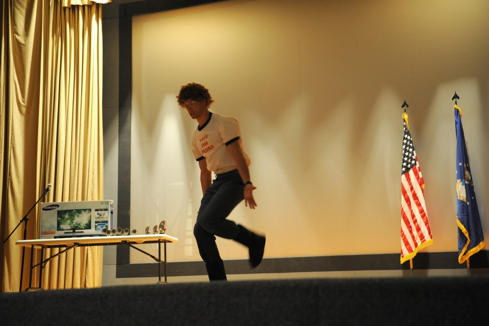 GOODFELLOW AIR FORCE BASE, Texas -- Airman 1st Class Micah Knoche, 316th Training Squadron student, performs a Napoleon Dynamite dance during the Student’s Got Talent competition at the Base Theater here March 11. The talents throughout the night ranged from rifle drill to piano playing. (U.S. Air Force photo/ Staff Sgt. Laura R. McFarlane)