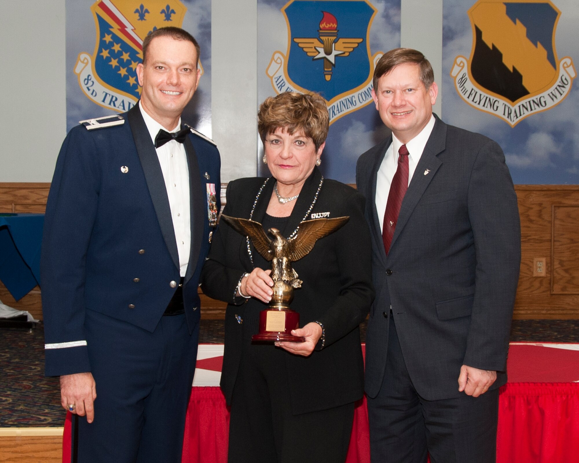 Col. Lance Bunch (left), 80th Flying Training Wing commander and George Gagnon, Air Education and Training Command director of International Training and Education (right), present Dee Ann Martin, ENJJPT Country Sponsor, the AETC International Student Support Award at Sheppard Air Force Base, Texas, on behalf of the ENJJPT sponsor program 8 Feb. 2014 (U.S. Air Force photo by Joshua Felton)
