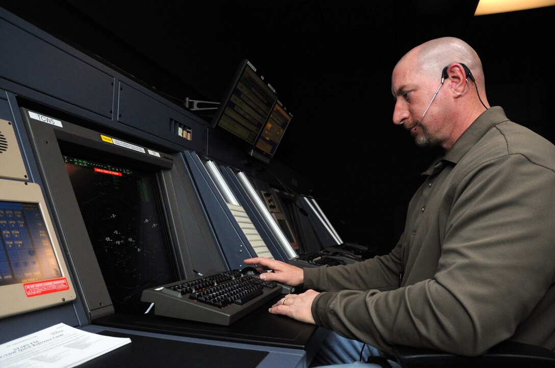 Brian Sullivan, 319th Operations Support Squadron Airfield Operations Automation manager, controls aircraft in the Radar Approach Control tower on Grand Forks Air Force Base, N.D., March 18, 2014. Sullivan was named the 2013 Air Traffic Controller of the Year by Air Mobility Command. (U.S. Air Force photo/Staff Sgt. David Dobrydney)