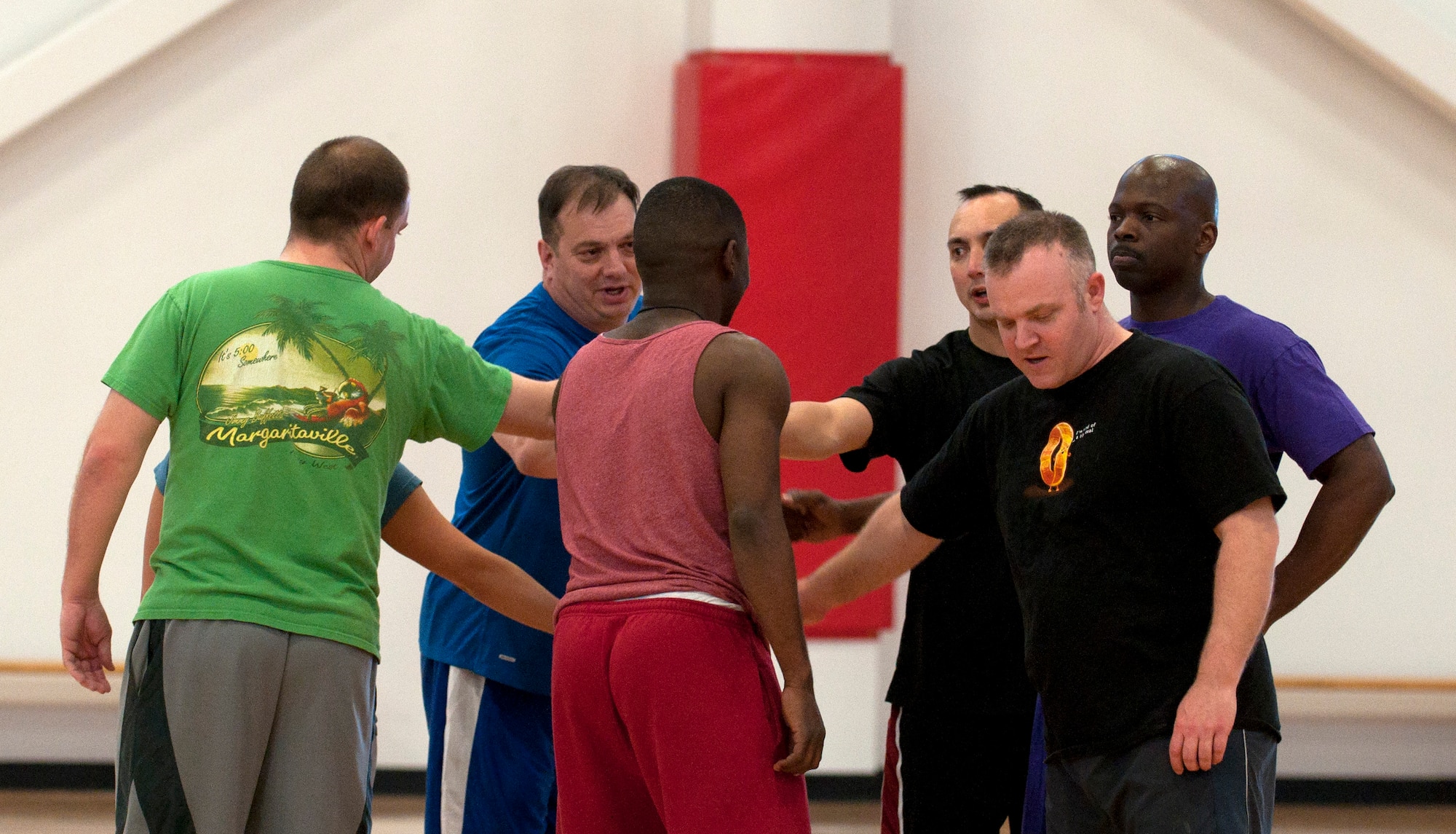The 90th Communication Squadron volleyball team rallies together for the next round of their match against the 90th Force Support Squadron volleyball team. (U.S. Air Force photo by Airman Malcolm Mayfield)